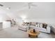 Bright upstairs bonus room with vaulted ceilings, white shiplap, and plush sofa seating at 729 Mills St, Raleigh, NC 27608