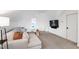 Bonus room with soft decor, a comfortable sofa, and a wall-mounted TV for entertainment at 729 Mills St, Raleigh, NC 27608