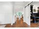 Open-concept living space with a view of home office and staircase at 729 Mills St, Raleigh, NC 27608