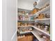 Organized pantry with white shelving, storage baskets and clear containers at 729 Mills St, Raleigh, NC 27608