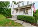 Front porch with white railings, rocking chairs, and a view of the landscaped front yard at 729 Mills St, Raleigh, NC 27608