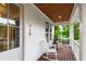 Front porch featuring white rocking chairs, a wood ceiling, and an inviting entrance at 729 Mills St, Raleigh, NC 27608