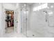 Elegant walk-in shower with a glass enclosure, marble tiles, and a view to the walk-in closet at 729 Mills St, Raleigh, NC 27608