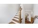 Bright staircase with wood treads, white risers, and view to the lower-level hallway and pantry at 729 Mills St, Raleigh, NC 27608