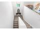 Upstairs hallway and staircase with crisp white walls, light-colored carpeting, and natural light at 729 Mills St, Raleigh, NC 27608