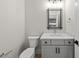 This half bathroom features a marble countertop and a modern mirror with unique black trim at 7417 Dover Hills Dr # 73, Wake Forest, NC 27587