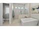 Modern bathroom with a glass enclosed shower and a soaking tub, as well as neutral tile at 7417 Dover Hills Dr # 73, Wake Forest, NC 27587