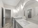 This bathroom has double vanities with white marble countertops, modern fixtures, and large round mirrors at 7417 Dover Hills Dr # 73, Wake Forest, NC 27587