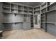 Spacious closet with custom shelving, drawers, wood floors, and a dressing area with large mirror at 7417 Dover Hills Dr # 73, Wake Forest, NC 27587
