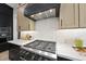 Close-up of a modern gas range, marble backsplash and modern hood at 7417 Dover Hills Dr # 73, Wake Forest, NC 27587