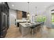 Modern kitchen features an island with seating, modern appliances and lighting at 7417 Dover Hills Dr # 73, Wake Forest, NC 27587