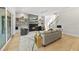 Open-concept living room with a fireplace, TV, hardwood floors, and easy access to the stairs at 7417 Dover Hills Dr # 73, Wake Forest, NC 27587