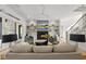 Bright living room featuring a fireplace, TV, ceiling fan, hardwood floors, and modern decor at 7417 Dover Hills Dr # 73, Wake Forest, NC 27587