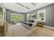 Bright main bedroom with three large windows, hardwood floors, and ceiling fan at 7417 Dover Hills Dr # 73, Wake Forest, NC 27587