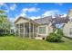 Well-maintained backyard featuring lush green grass, screened porch, and appealing landscaping at 79 Heatherwood Dr, Chapel Hill, NC 27516