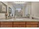 Bathroom features a double vanity with granite countertops and large frameless mirror at 79 Heatherwood Dr, Chapel Hill, NC 27516