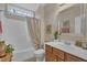 Well-lit bathroom features a shower-tub combo, vanity with a wood finish, and a framed mirror at 79 Heatherwood Dr, Chapel Hill, NC 27516