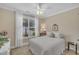Cozy bedroom with neutral walls, soft carpet, a ceiling fan, and a sunlit window at 79 Heatherwood Dr, Chapel Hill, NC 27516