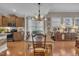 Traditional dining room featuring hardwood floors, a decorative chandelier, and ample natural light at 79 Heatherwood Dr, Chapel Hill, NC 27516