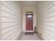 Stylish covered front entry with a solid wood door, neutral siding, and modern lighting at 79 Heatherwood Dr, Chapel Hill, NC 27516