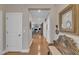 Inviting hallway with hardwood floors, white trim, doors, and classic decor throughout the home at 79 Heatherwood Dr, Chapel Hill, NC 27516