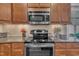The kitchen highlights include a stainless steel microwave and stovetop with overhead lighting and ample cabinet space at 79 Heatherwood Dr, Chapel Hill, NC 27516