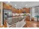 Bright kitchen boasting a central island with granite countertops, stainless appliances, and warm wood cabinets at 79 Heatherwood Dr, Chapel Hill, NC 27516