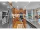 Kitchen area features a stainless steel refrigerator, granite countertops, and modern appliances at 79 Heatherwood Dr, Chapel Hill, NC 27516
