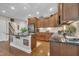 Spacious kitchen island with granite countertops, stainless steel appliances, and dark wood cabinetry at 79 Heatherwood Dr, Chapel Hill, NC 27516