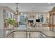 Gourmet kitchen featuring an island with granite countertop, stainless sink, and views of the living room at 79 Heatherwood Dr, Chapel Hill, NC 27516