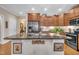 Kitchen island offering granite countertops, a stainless steel fridge, and wood cabinets at 79 Heatherwood Dr, Chapel Hill, NC 27516