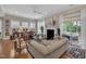 Spacious living room boasting hardwood floors, a fireplace, and access to an outdoor area at 79 Heatherwood Dr, Chapel Hill, NC 27516