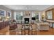Cozy living room with a fireplace, hardwood floors, and large windows providing plenty of natural light at 79 Heatherwood Dr, Chapel Hill, NC 27516