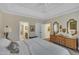 Bright main bedroom features a tray ceiling, ensuite access, and decorative mirrors and accents at 79 Heatherwood Dr, Chapel Hill, NC 27516