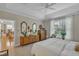 Bright main bedroom features a tray ceiling, large window, and decorative mirrors and accents at 79 Heatherwood Dr, Chapel Hill, NC 27516