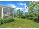 Expansive yard featuring well-manicured landscaping, lush greenery, and views of the screened-in porch at 79 Heatherwood Dr, Chapel Hill, NC 27516