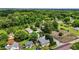 An aerial view shows a neighborhood with tree-lined streets and well-maintained homes in a tranquil, wooded area at 800 Linens St, Graham, NC 27253