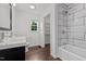 Bright bathroom features a modern vanity, tiled shower, and ample storage at 800 Linens St, Graham, NC 27253