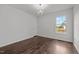 Bright bedroom features hardwood floors and a modern chandelier at 800 Linens St, Graham, NC 27253