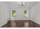 Bedroom boasts hardwood floors, built-in shelving, and multiple windows at 800 Linens St, Graham, NC 27253