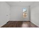 Bright bedroom features hardwood floors, a window with a view, and a classic door at 800 Linens St, Graham, NC 27253