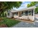 Charming home featuring a well-manicured lawn, neat flowerbeds, and inviting curb appeal at 800 Linens St, Graham, NC 27253