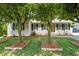 Charming single-story home with a well-maintained front yard, featuring black shutters and lush landscaping at 800 Linens St, Graham, NC 27253