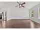 Spacious living room featuring hardwood floors, a ceiling fan, and natural light from large windows at 800 Linens St, Graham, NC 27253