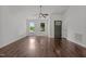 Bright living room with hardwood floors, two windows, and a ceiling fan near the entry door at 800 Linens St, Graham, NC 27253