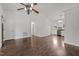 Open-concept living room showcasing hardwood floors, a ceiling fan, and seamless transition to the kitchen at 800 Linens St, Graham, NC 27253