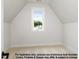 Bright attic room with a window and neutral carpet, perfect for storage or conversion at 8021 Bud Morris Rd, Wake Forest, NC 27587