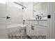 Modern bathroom features white subway tile, gray tile flooring, and black hardware at 8021 Bud Morris Rd, Wake Forest, NC 27587