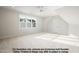 Large bedroom with a big window offering outdoor views, neutral tones, and a carpeted floor at 8021 Bud Morris Rd, Wake Forest, NC 27587