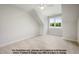 Serene bedroom with neutral tones, a vaulted ceiling, and a large window providing ample natural light at 8021 Bud Morris Rd, Wake Forest, NC 27587